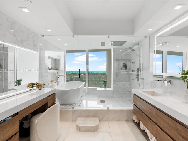 bathroom featuring tile patterned floors, vanity, and plus walk in shower