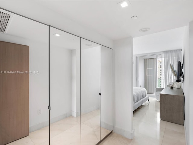 bedroom featuring light tile patterned flooring and a closet