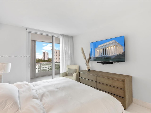 bedroom with access to exterior and a wall of windows