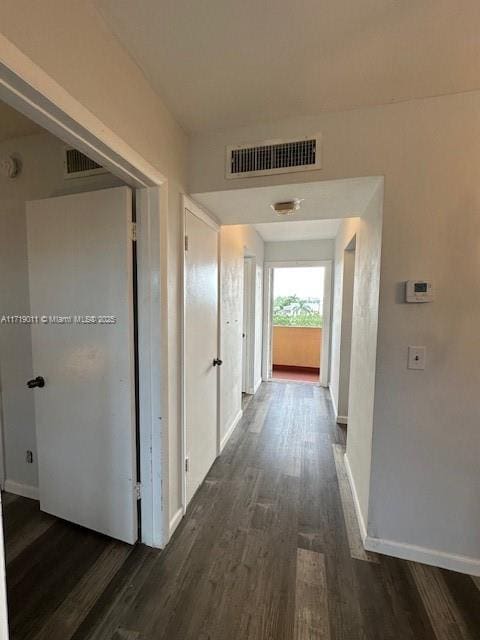 corridor featuring dark wood-type flooring