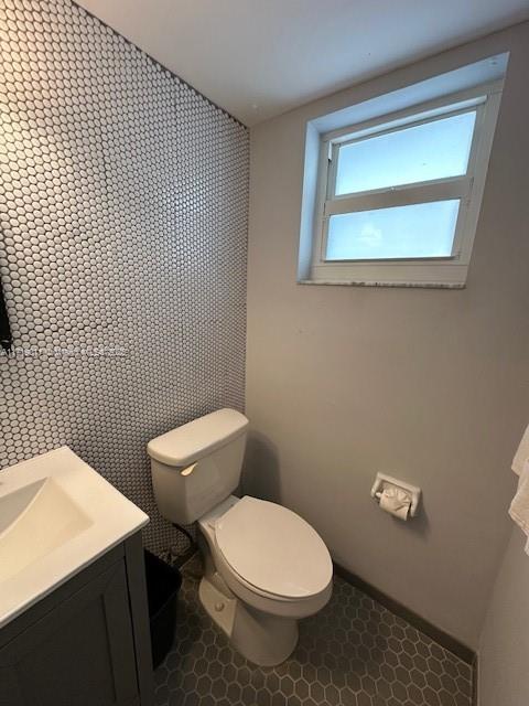 bathroom featuring toilet and vanity