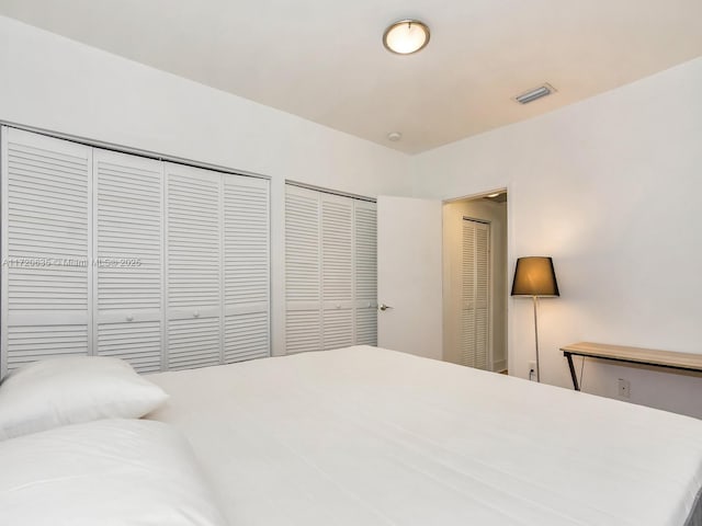 bedroom with two closets