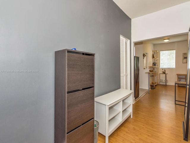 corridor with light hardwood / wood-style floors