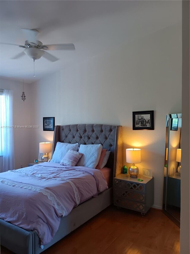 bedroom with hardwood / wood-style floors and ceiling fan