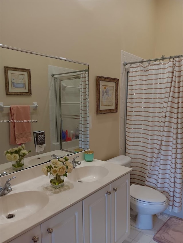 bathroom with tile patterned flooring, vanity, curtained shower, and toilet