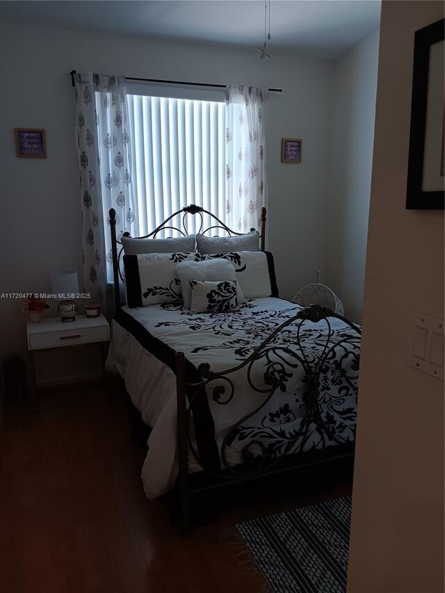 bedroom featuring dark wood-type flooring