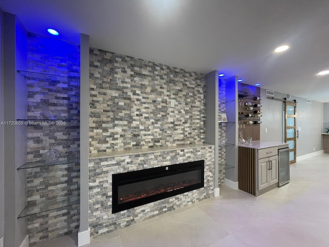 bar featuring a fireplace, a barn door, and wine cooler