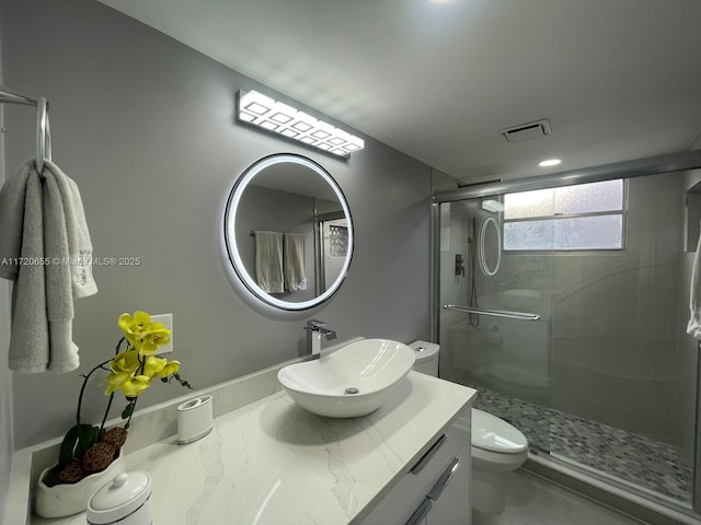 bathroom with toilet, an enclosed shower, and vanity