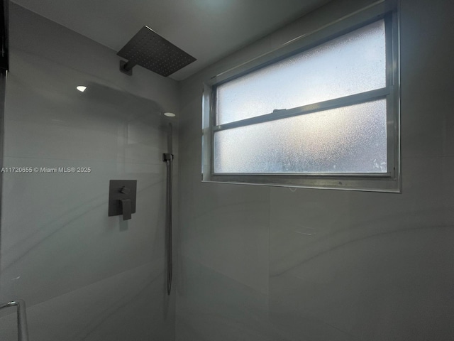 bathroom featuring walk in shower and a wealth of natural light