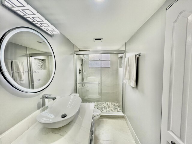 bathroom with vanity, toilet, and walk in shower