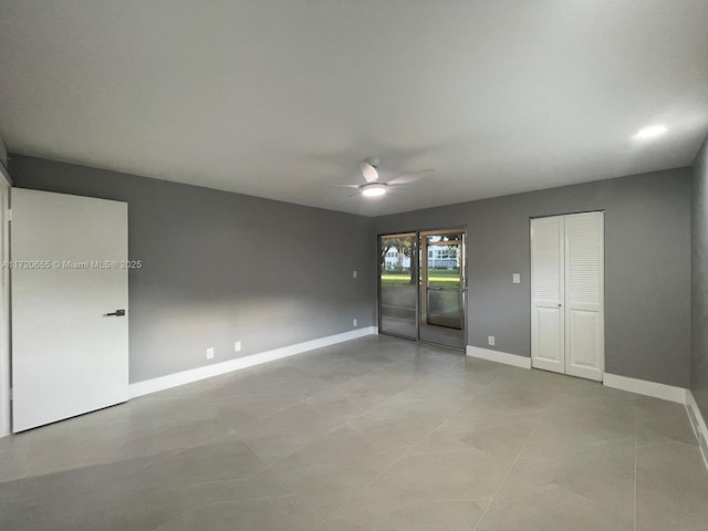 unfurnished room featuring ceiling fan and light tile patterned floors