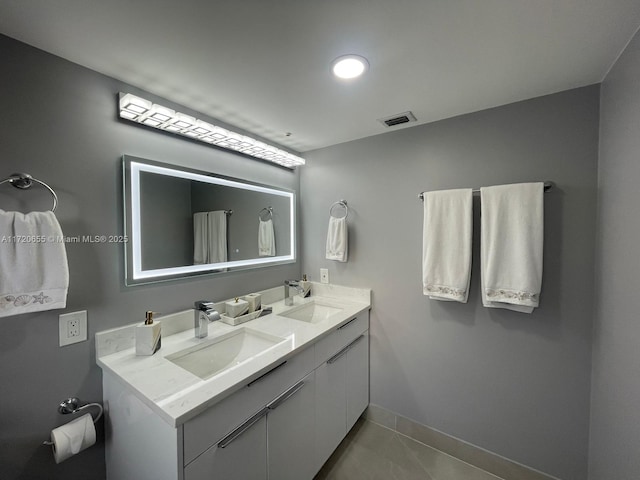 bathroom with tile patterned flooring and vanity