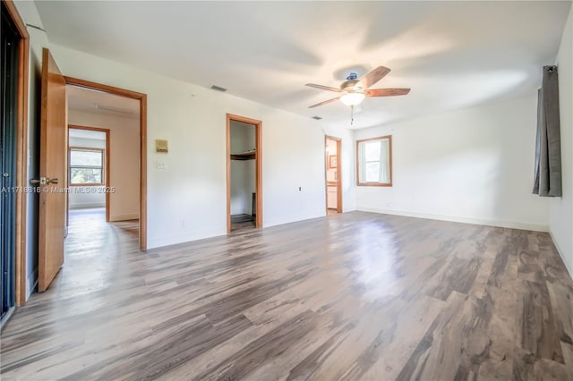 unfurnished room with ceiling fan and wood-type flooring