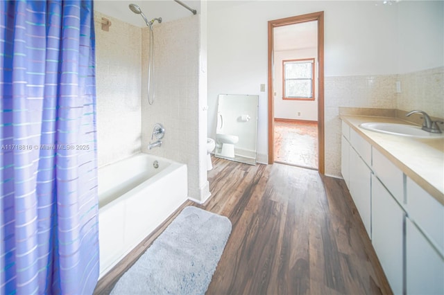 bathroom featuring shower / bath combination with curtain, vanity, and wood-type flooring