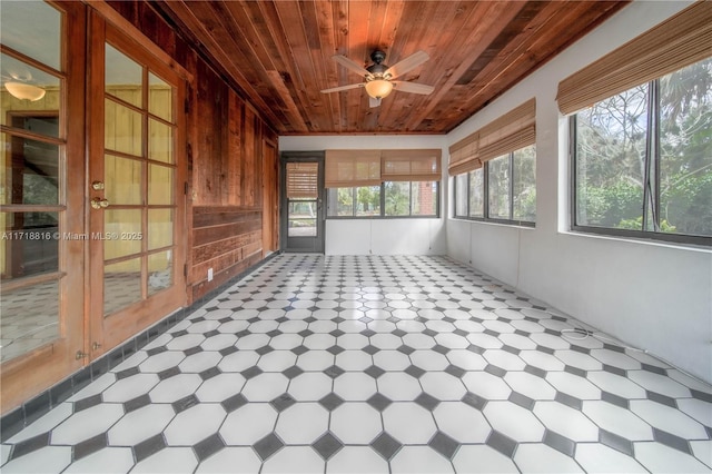 unfurnished sunroom featuring ceiling fan and wooden ceiling