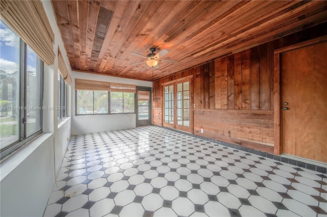 unfurnished sunroom featuring ceiling fan and wooden ceiling