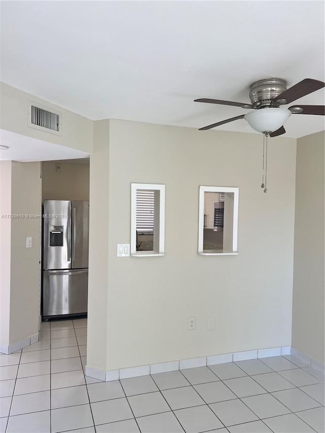 spare room with light tile patterned floors and ceiling fan