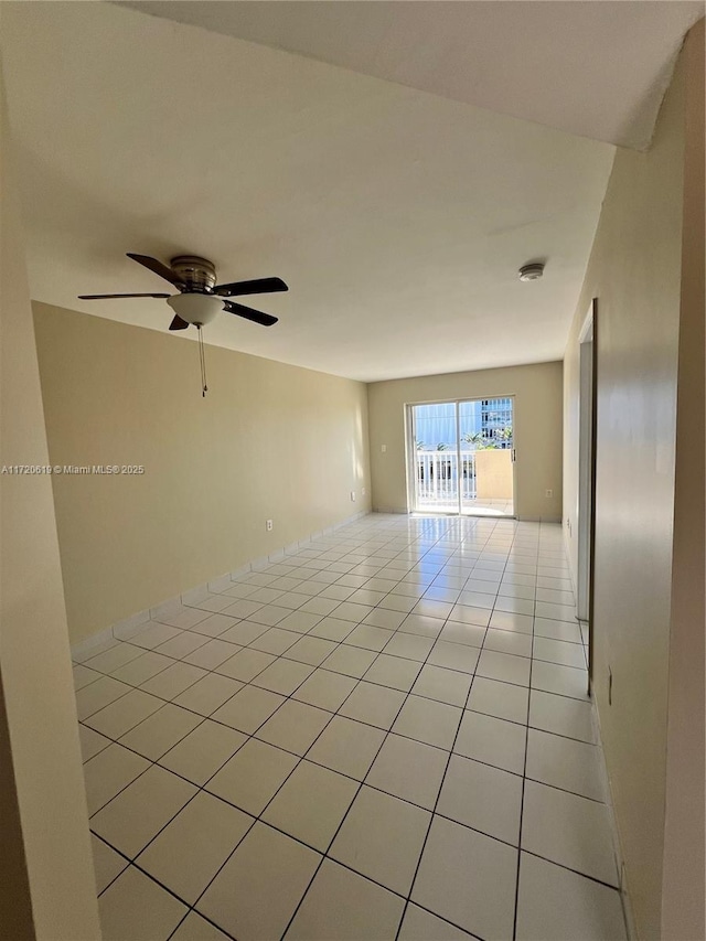 unfurnished room with ceiling fan and light tile patterned flooring