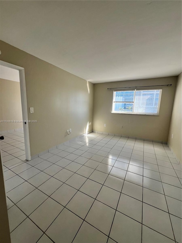 empty room with light tile patterned flooring