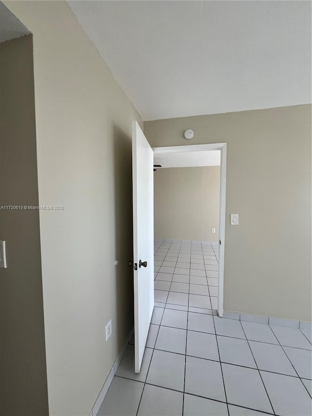 corridor with light tile patterned floors