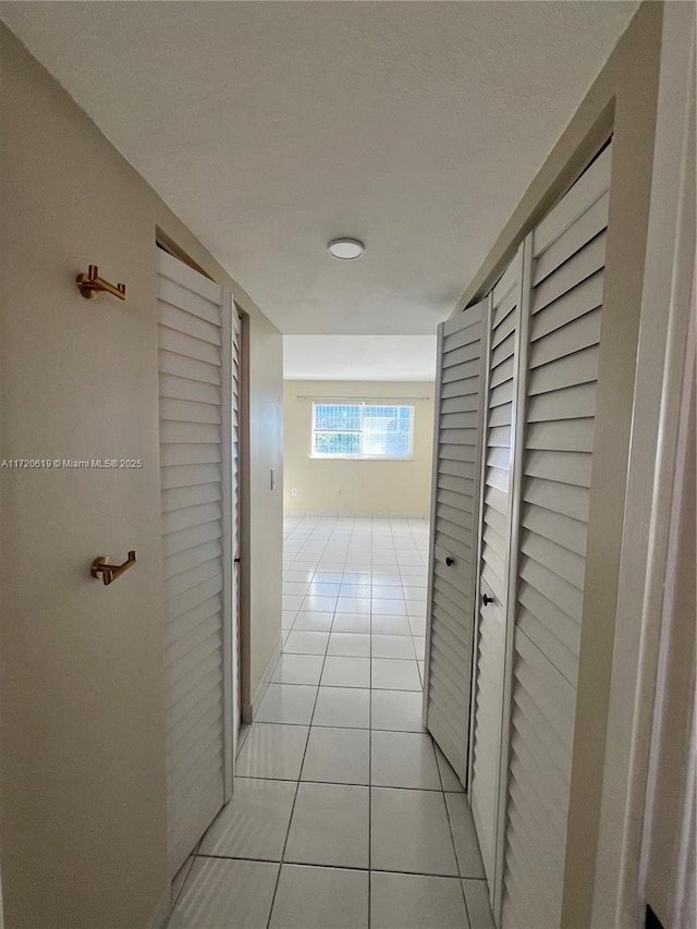 hall featuring light tile patterned flooring