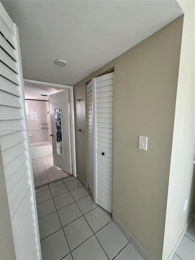 hallway featuring light tile patterned floors