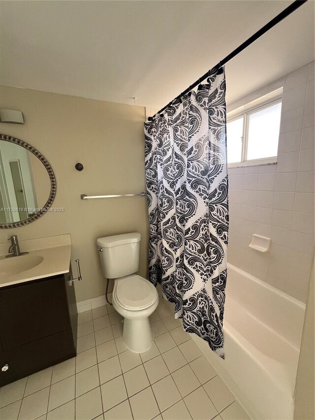 full bathroom featuring tile patterned flooring, vanity, toilet, and shower / tub combo with curtain