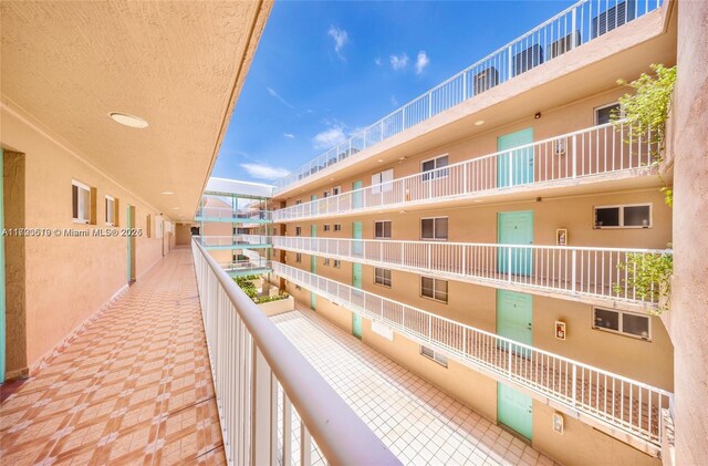 corridor featuring elevator and tile patterned flooring