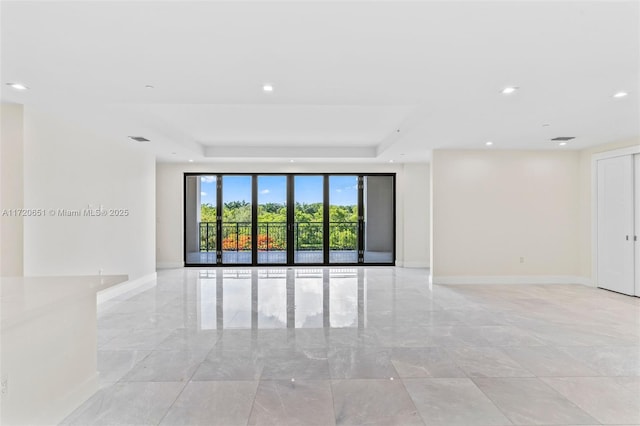 empty room featuring a raised ceiling