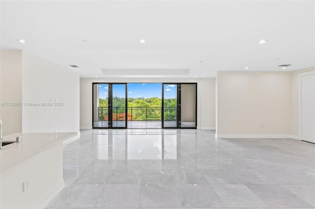 empty room with a raised ceiling