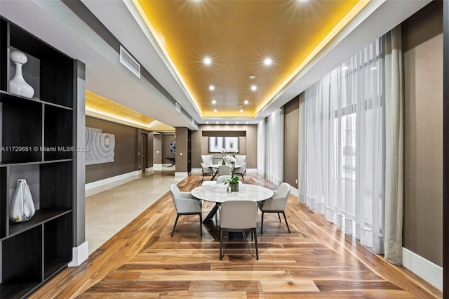 dining space featuring a raised ceiling