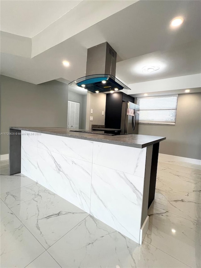 kitchen featuring island exhaust hood, stainless steel fridge, and kitchen peninsula