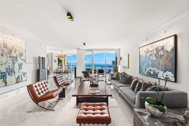 living room featuring a water view and expansive windows