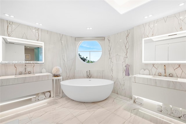 bathroom with vanity and a tub to relax in