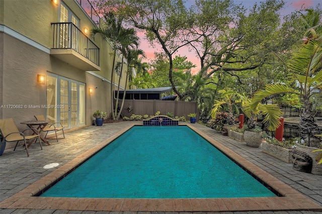 view of swimming pool featuring a patio area and a fenced in pool