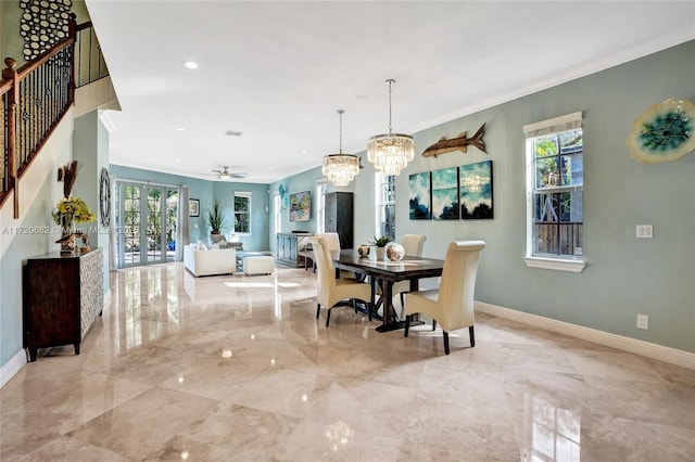 dining space featuring ceiling fan with notable chandelier and ornamental molding