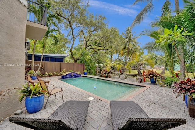 view of pool with pool water feature and a patio