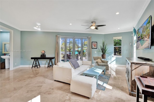 living room with a ceiling fan, baseboards, ornamental molding, and french doors