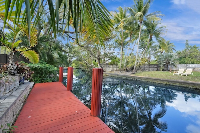 dock area with a fenced in pool