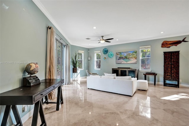 living room with ceiling fan, a healthy amount of sunlight, and crown molding