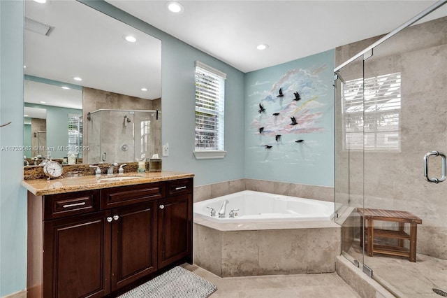 bathroom featuring shower with separate bathtub, vanity, and tile patterned floors