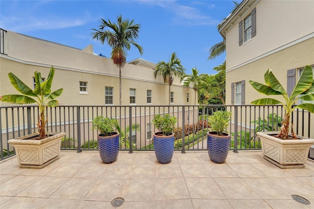 view of patio with french doors and a balcony