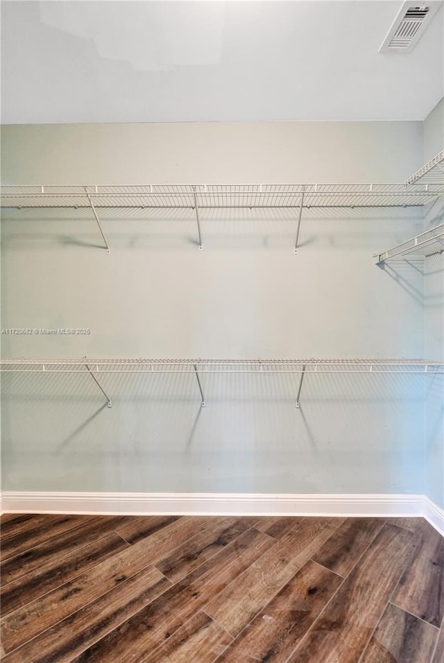 spacious closet with wood finished floors and visible vents