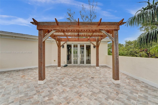 view of front facade with stucco siding, a garage, a balcony, and decorative driveway