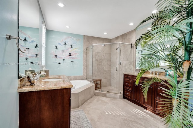 bathroom featuring tile patterned floors, recessed lighting, a shower stall, a garden tub, and vanity