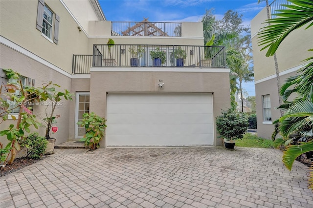 exterior space featuring a garage and a balcony