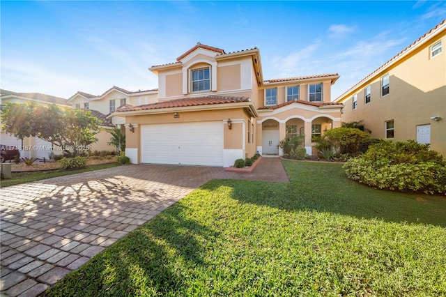 mediterranean / spanish home with a front lawn and a garage