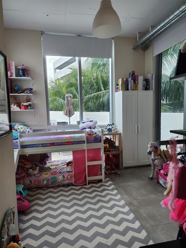 recreation room featuring plenty of natural light and concrete flooring