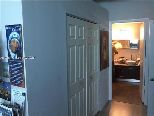 hallway with tile patterned floors and sink