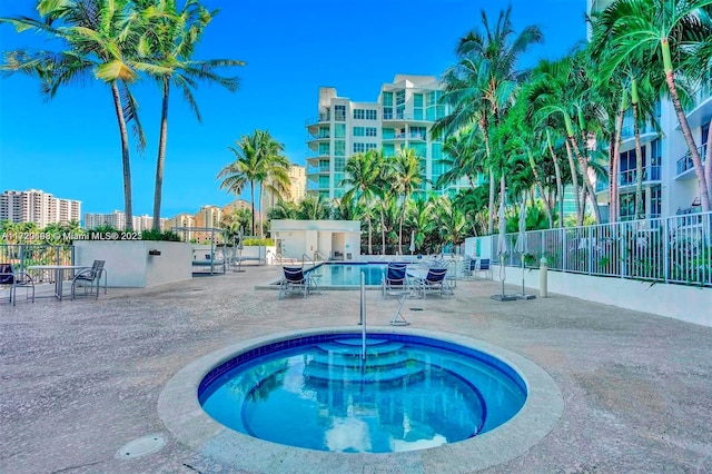 view of pool featuring a patio area and a hot tub